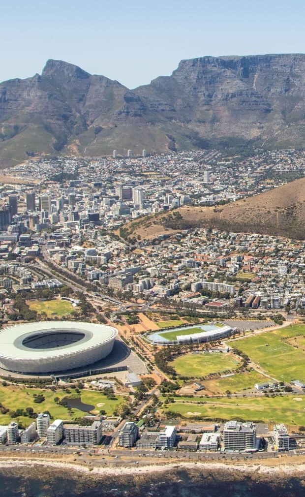 Aerial view of Cape Town Stadium with Table Mountain and Lion's Head behind it